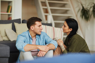 Couple sitting on living talking calmly